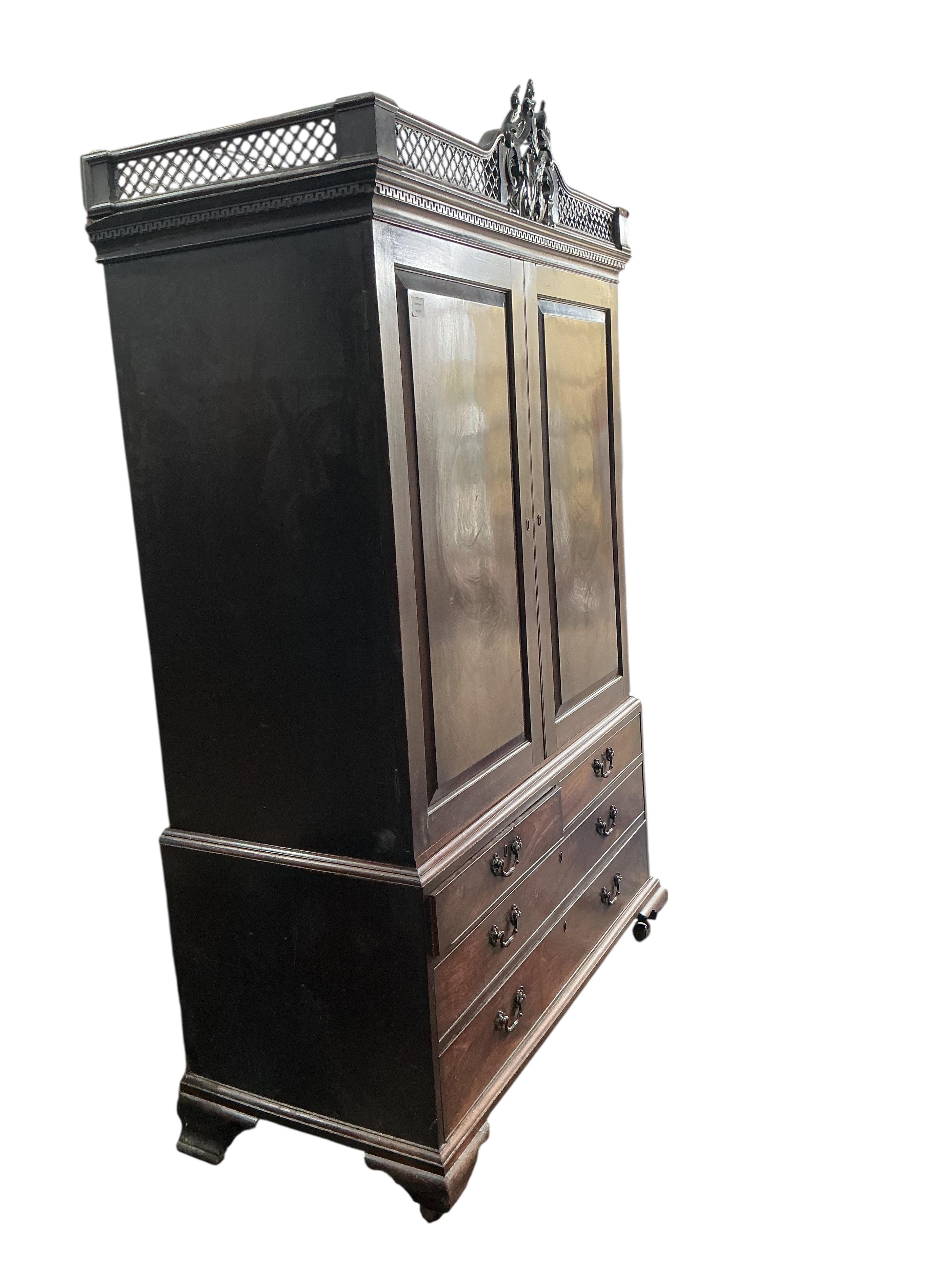 A George III Cuban mahogany linen press, lacking trays, converted to a hanging wardrobe, width 124cm, depth 60cm, height 210cm